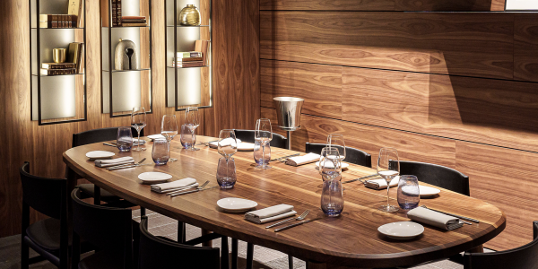A long wooden table with modern place settings at Toscana Divino, one of the best Italian restaurants in Miami.